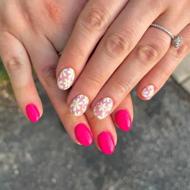 Pink nails with white daisy designs